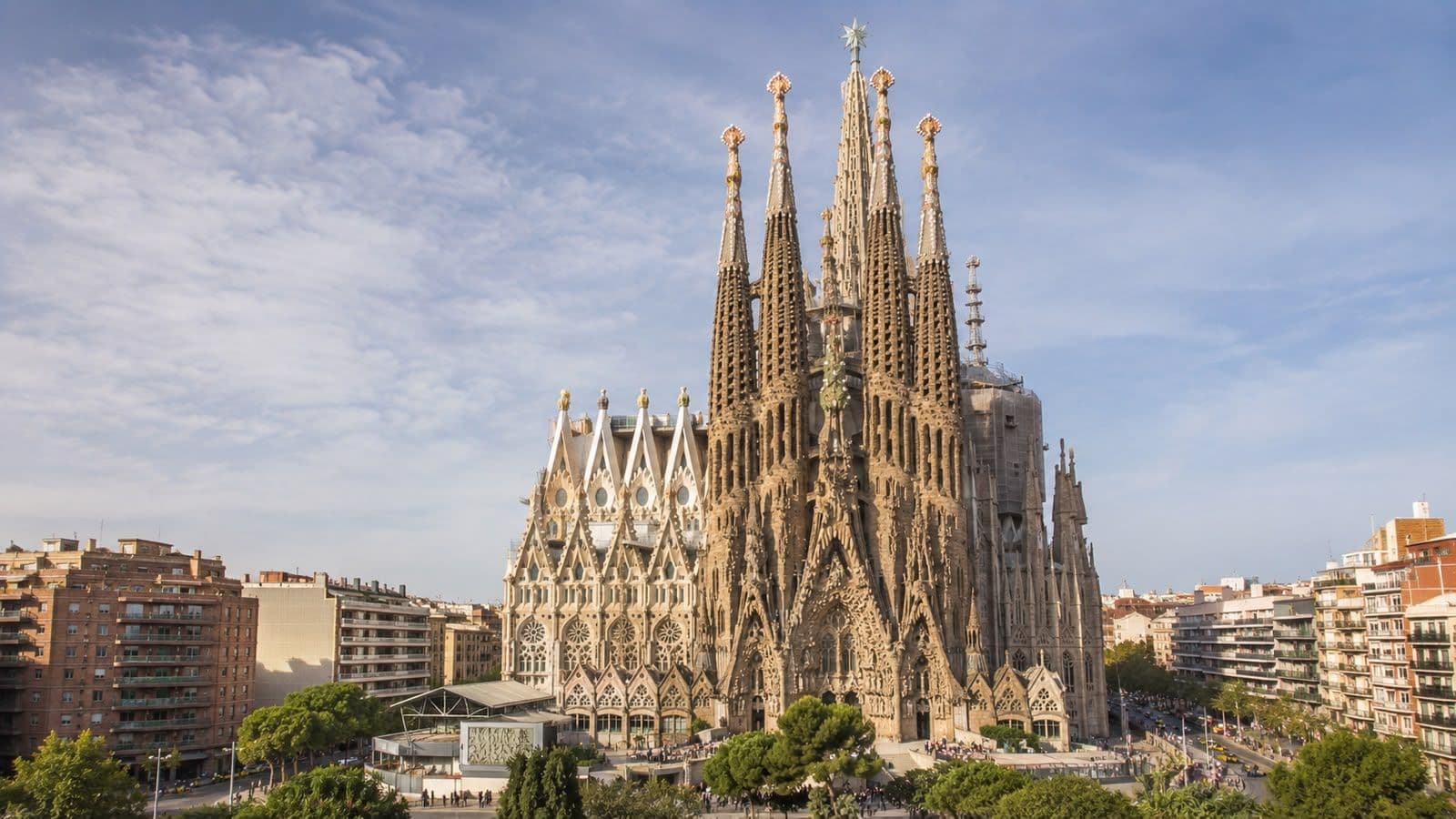 Sagrada Família in Barcelona, Spain, surrounded by the city skyline under a clear blue sky