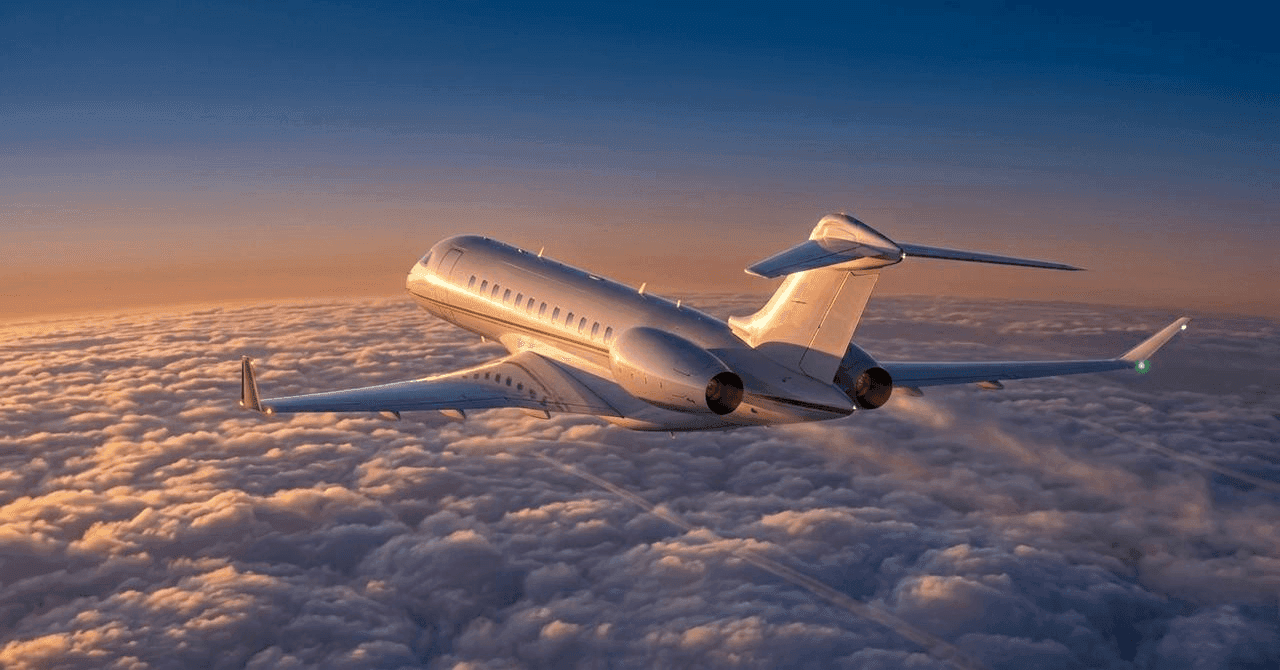 Long-range business jet cruising above a cloud layer at sunset, showcasing luxury private aviation and heavy jet travel capabilities.