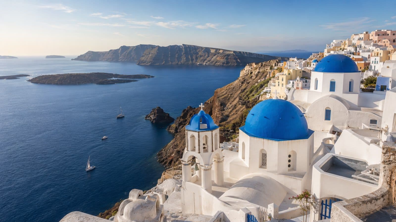 Santorini, Greece, with whitewashed cliffside buildings and blue-domed churches overlooking the Aegean Sea