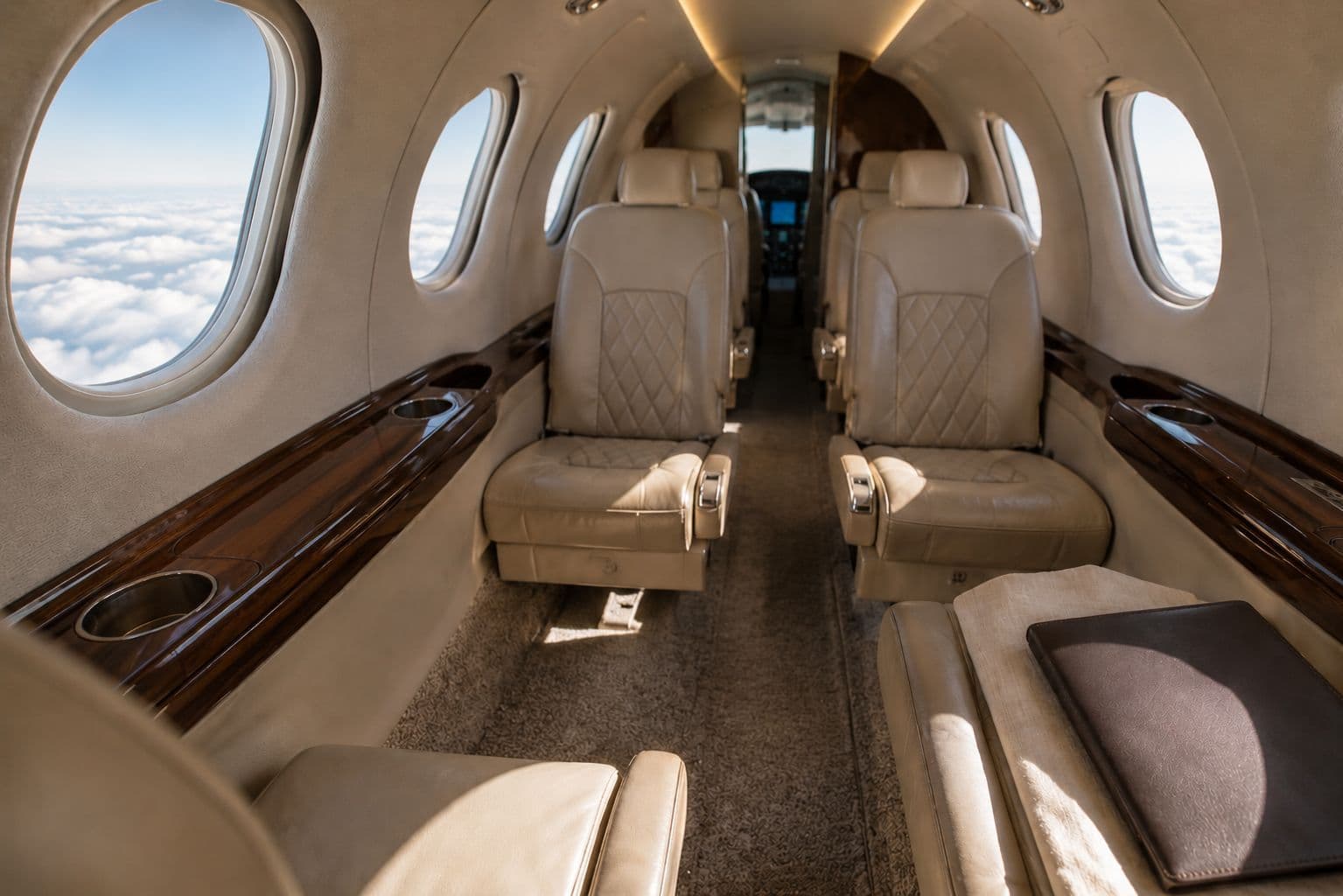 The interior of a very light jet featuring a compact executive cabin with premium leather seating